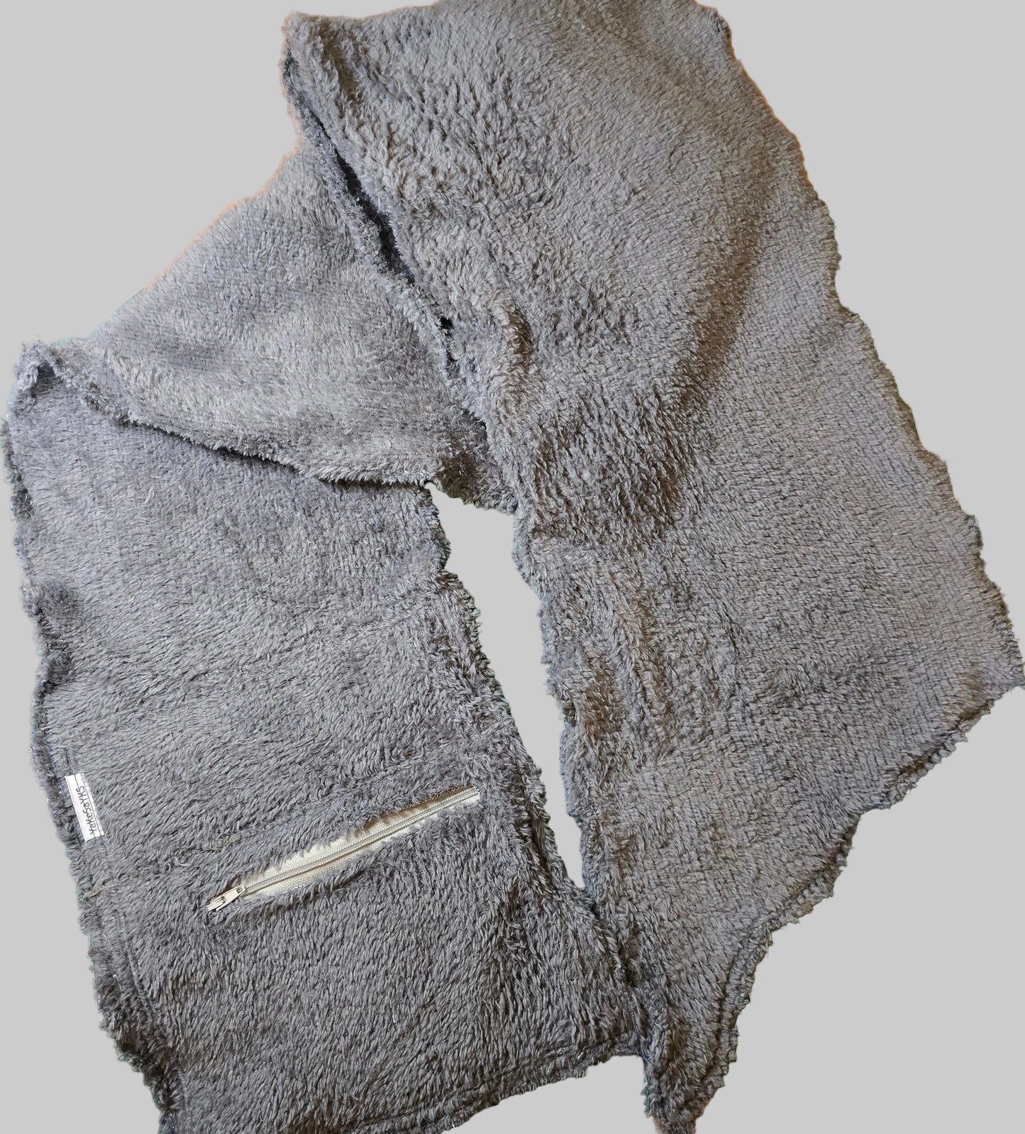 Multi-purpose scarf/wrap with a concealed secure pocket, combining stylish design with convenient storage for everyday and travel essentials.