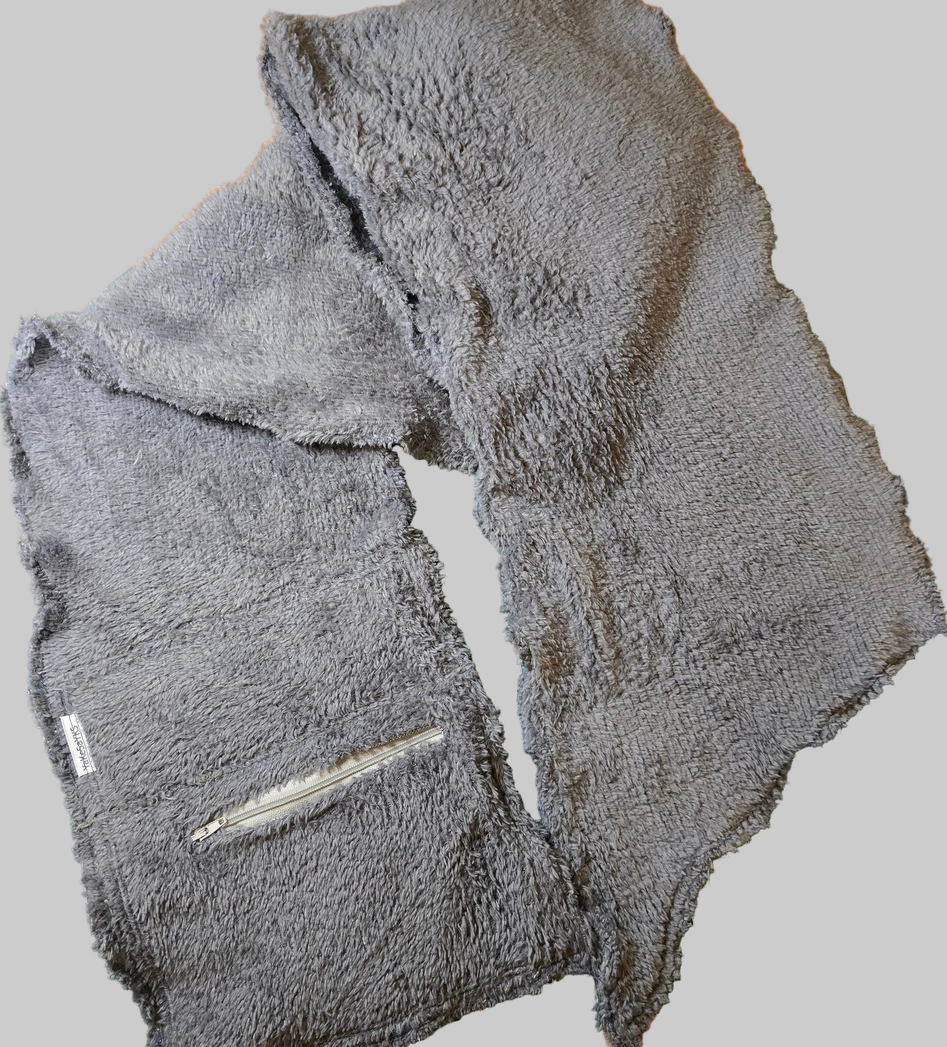 Multi-purpose scarf/wrap with a concealed secure pocket, combining stylish design with convenient storage for everyday and travel essentials.