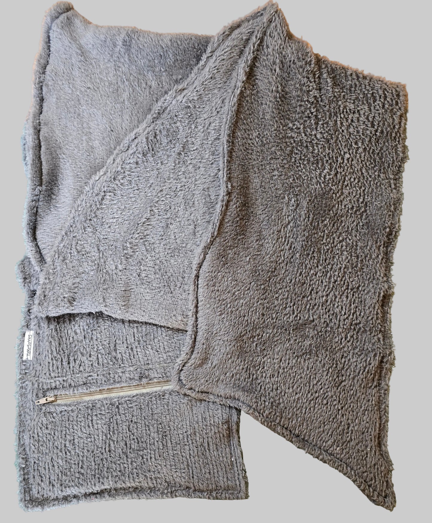 Multi-purpose scarf/wrap with a concealed secure pocket, combining stylish design with convenient storage for everyday and travel essentials.